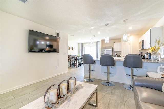 living room with a textured ceiling