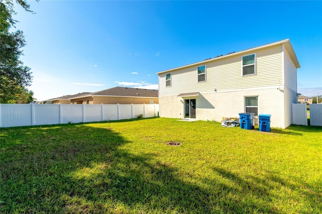 rear view of house with a yard