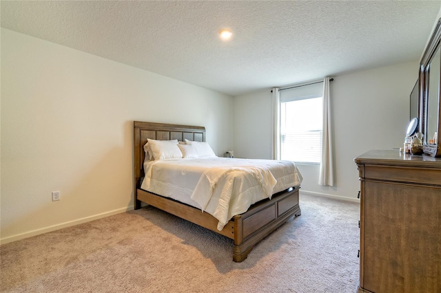 carpeted bedroom featuring a textured ceiling