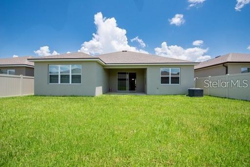 rear view of house with a lawn