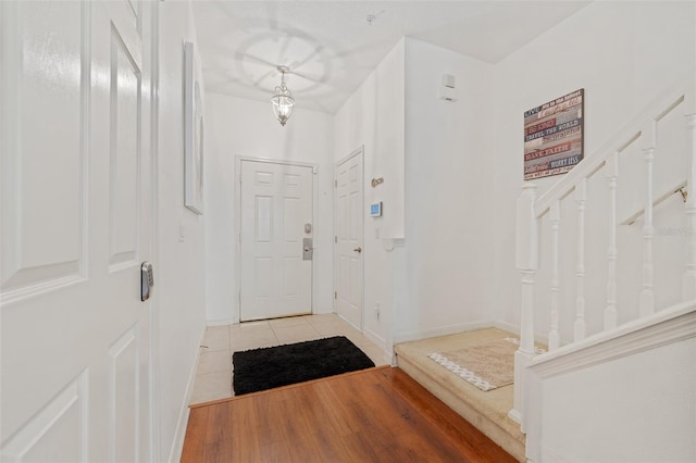 entryway with hardwood / wood-style flooring