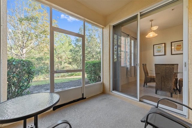 sunroom / solarium featuring a healthy amount of sunlight