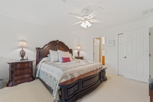 bedroom featuring ensuite bath, ceiling fan, and light colored carpet