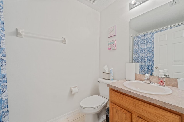 bathroom with tile patterned flooring, vanity, toilet, and walk in shower