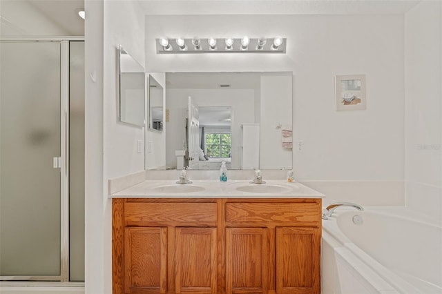 bathroom with shower with separate bathtub and vanity