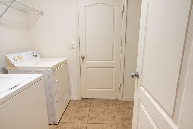 washroom featuring light tile patterned floors and washer and dryer