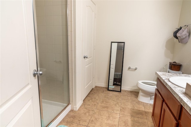 bathroom with tile patterned flooring, vanity, toilet, and a shower with shower door