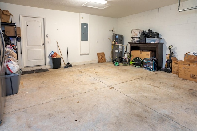 garage featuring electric panel and hybrid water heater