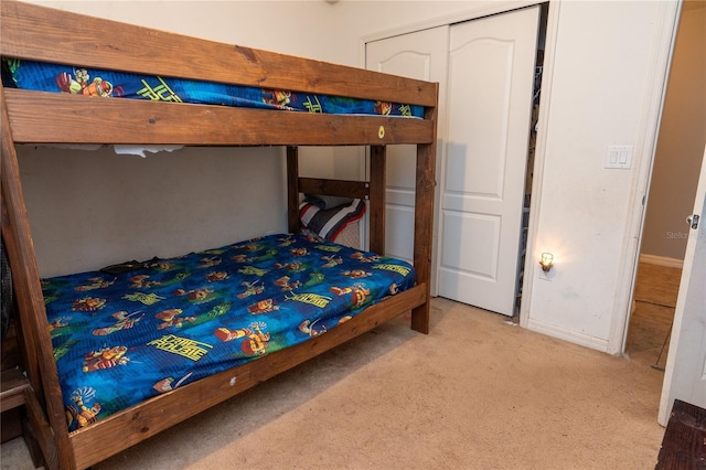 bedroom with light carpet and a closet