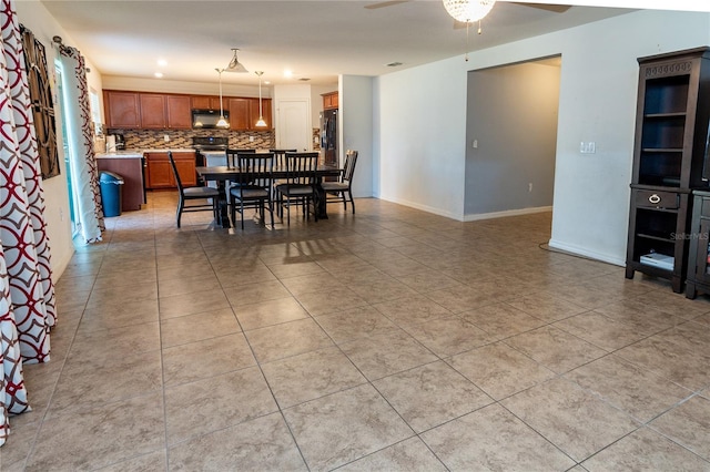 tiled dining space featuring ceiling fan