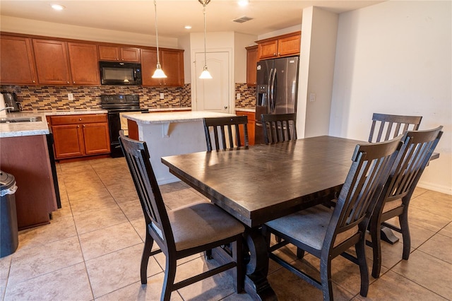 dining space with light tile patterned flooring and sink