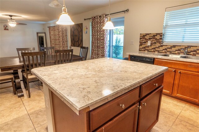 kitchen with ceiling fan, sink, a center island, black dishwasher, and pendant lighting