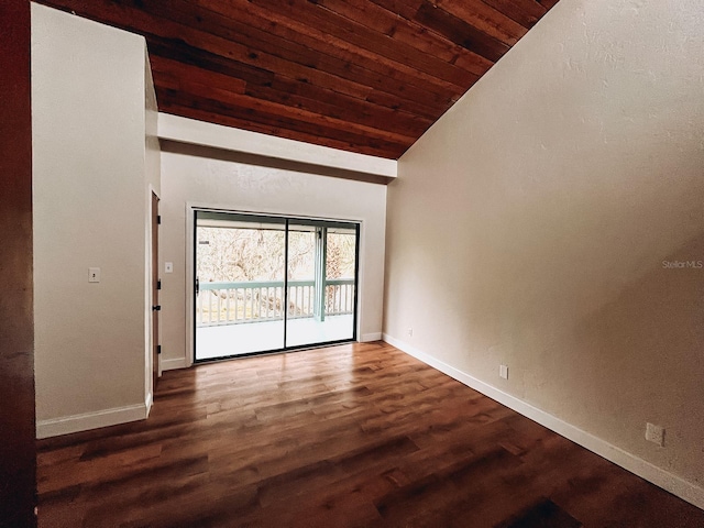 empty room featuring dark hardwood / wood-style floors, lofted ceiling, and wood ceiling