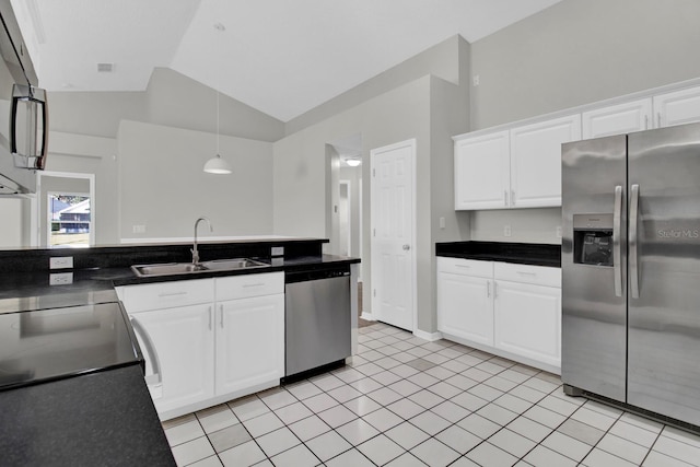 kitchen with lofted ceiling, sink, light tile patterned floors, white cabinetry, and stainless steel appliances