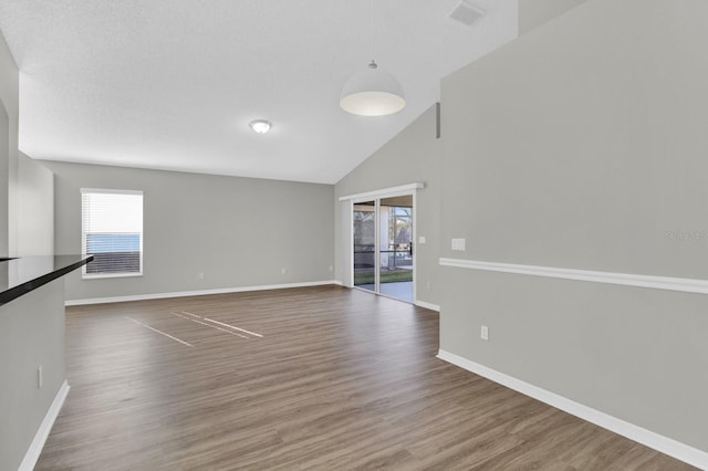 interior space with hardwood / wood-style floors and high vaulted ceiling