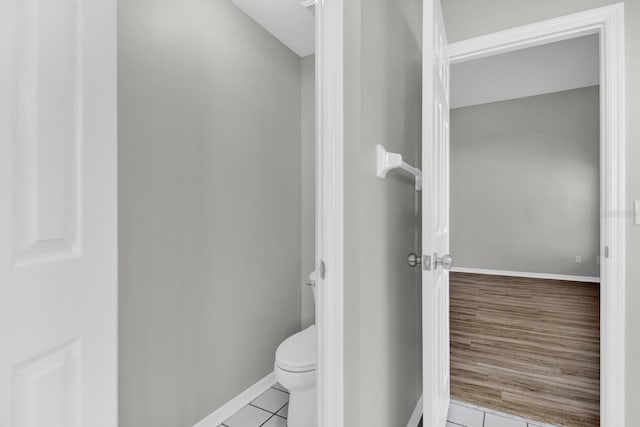 bathroom featuring hardwood / wood-style flooring and toilet