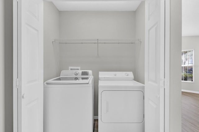 washroom featuring washing machine and dryer and hardwood / wood-style floors