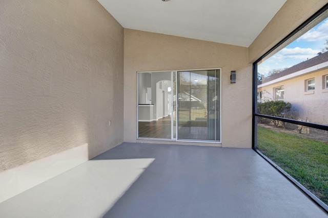 unfurnished sunroom with vaulted ceiling