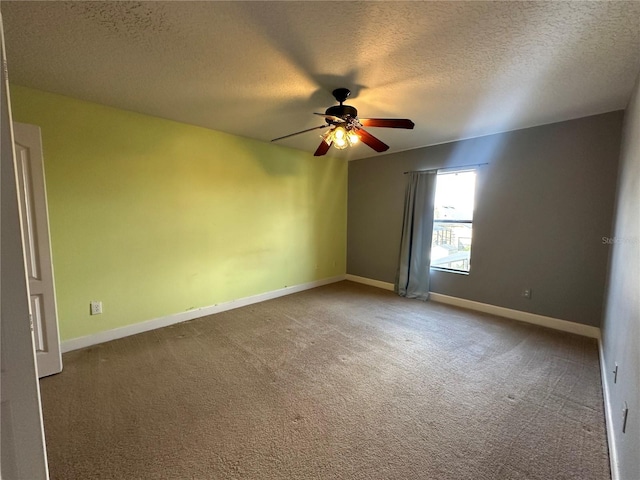 unfurnished room with carpet flooring, ceiling fan, and a textured ceiling