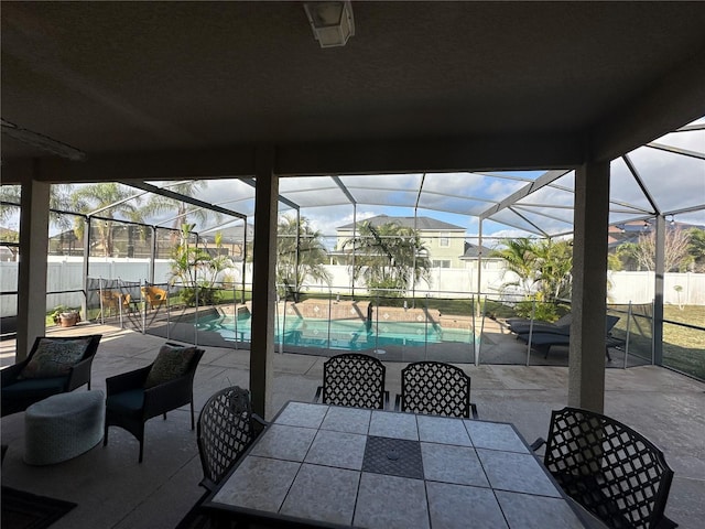 view of patio / terrace with a fenced in pool and glass enclosure