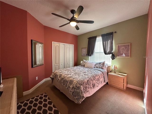 bedroom featuring carpet, a textured ceiling, a closet, and ceiling fan