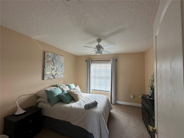 carpeted bedroom featuring a textured ceiling and ceiling fan