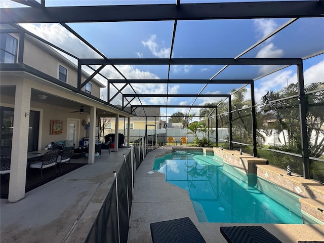 view of pool featuring an outdoor living space, ceiling fan, a patio, and glass enclosure