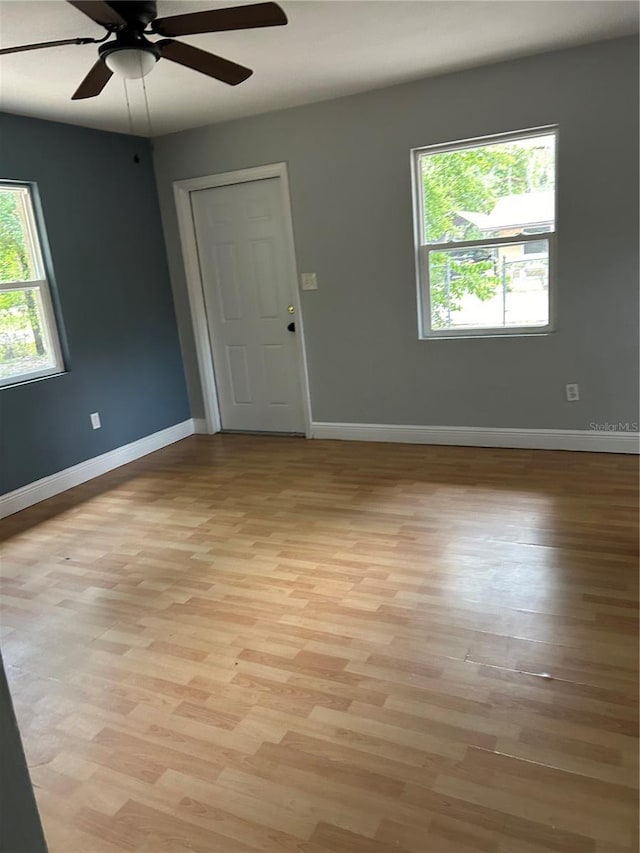 unfurnished room with ceiling fan and light wood-type flooring