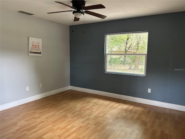 empty room with ceiling fan and light wood-type flooring