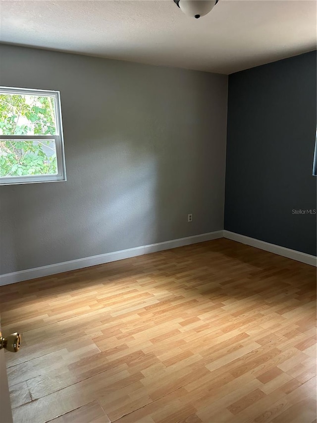 unfurnished room featuring light hardwood / wood-style flooring