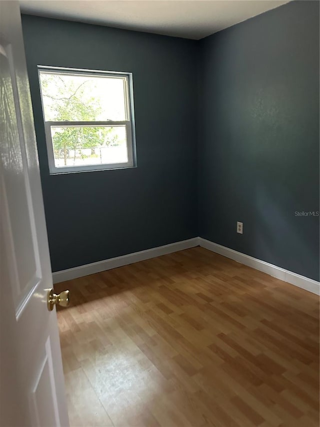 spare room featuring hardwood / wood-style floors