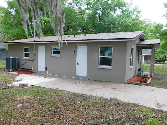 back of house featuring central air condition unit and a patio area