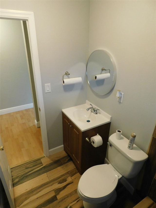 bathroom featuring hardwood / wood-style floors, vanity, and toilet