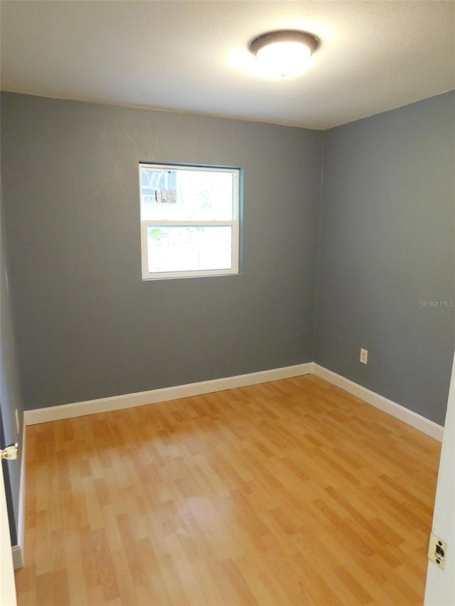 unfurnished room with hardwood / wood-style flooring