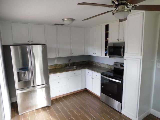 kitchen featuring sink, dark hardwood / wood-style floors, ceiling fan, white cabinetry, and stainless steel appliances