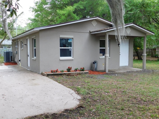 bungalow-style home with cooling unit and a patio area