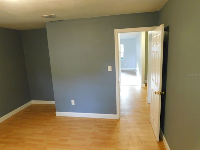 spare room featuring light hardwood / wood-style flooring