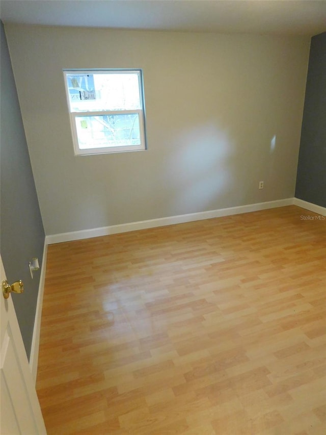 unfurnished room with light hardwood / wood-style floors