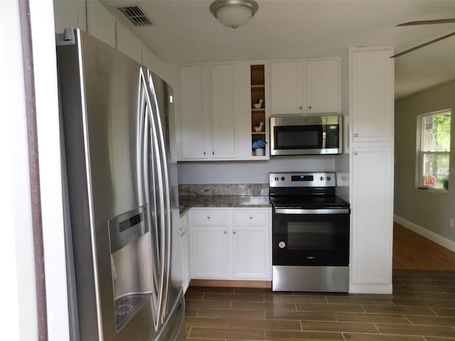 kitchen featuring white cabinets, stainless steel appliances, dark hardwood / wood-style floors, and ceiling fan