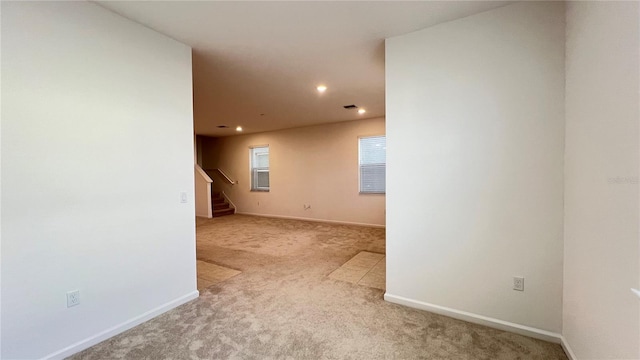 unfurnished room with light carpet