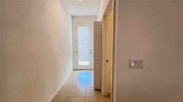 hall with light tile patterned floors