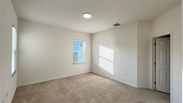 empty room featuring light colored carpet