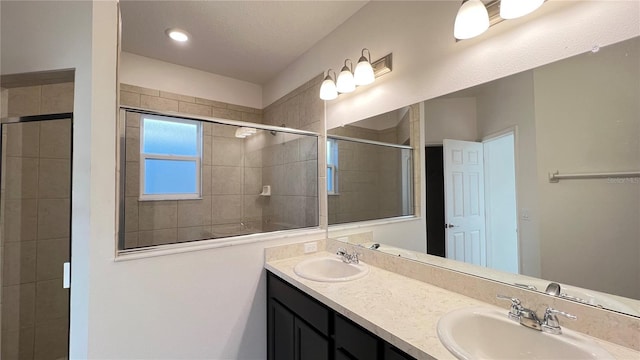 bathroom with vanity and a shower with door