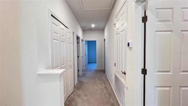 corridor with light colored carpet