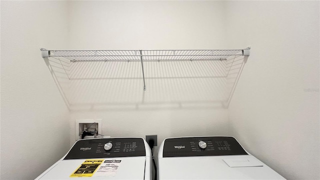 clothes washing area featuring washer and clothes dryer