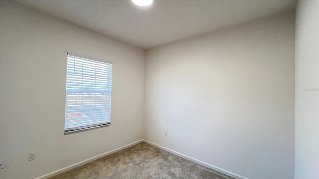 unfurnished room with light carpet