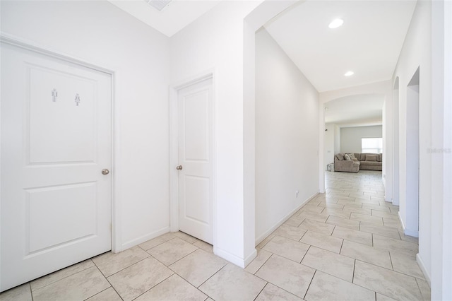 corridor featuring light tile patterned floors