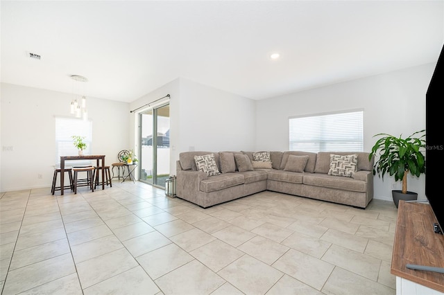 living room with a water view and light tile patterned floors