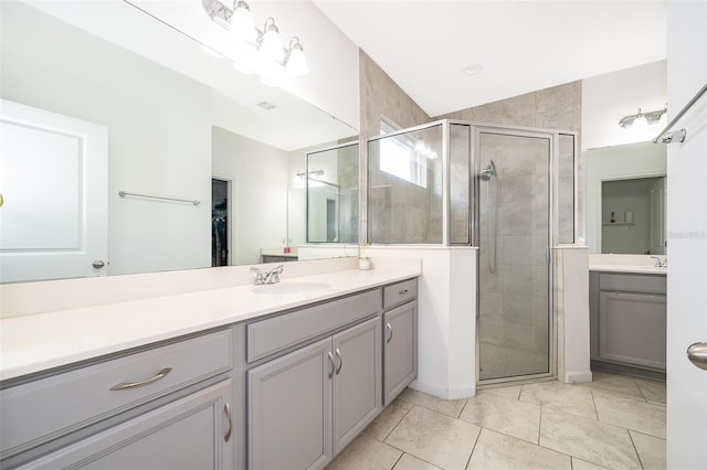 bathroom with tile patterned flooring, vanity, and an enclosed shower