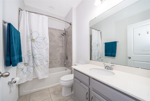 full bathroom with tile patterned floors, shower / tub combo with curtain, vanity, and toilet